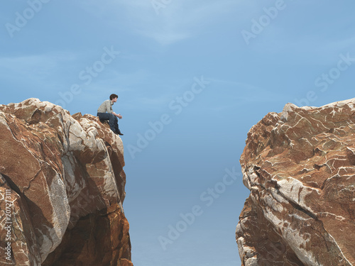 Canvastavla Young man on a rock in front of a chasm.