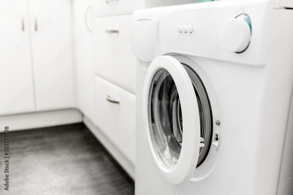 washing machine built in the interior of a modern small kitchen Stock