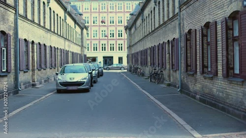 Old streets of Copehagen with cars and bicycles, ancient architecture, history photo