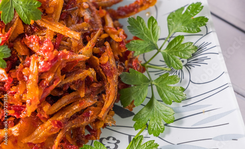 Malay dish stir fried chili with deep fried anchovies and potato cubes or locally known as ikan bilis goreng berlada. photo