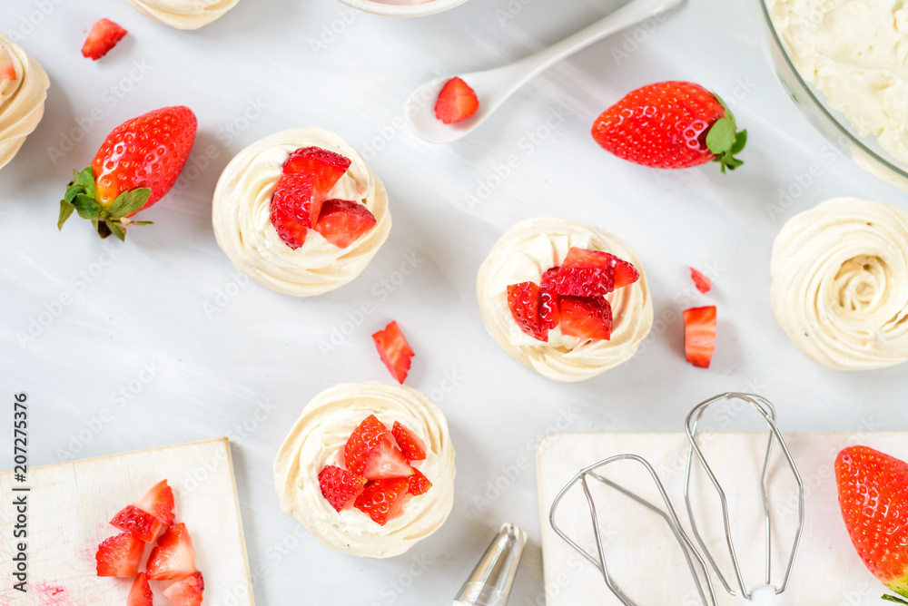 A small meringue Pavlova dessert with some strawberry slices . Top view. pattern A small meringue Pavlova dessert with some strawberry slices . Top view. pattern