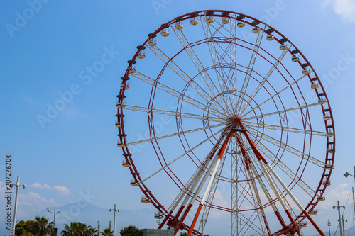 Ferris wheel on embankment of Batumi at sunny day