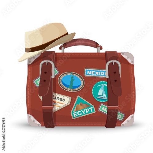 Retro suitcase with travel stickers and fedora hat
