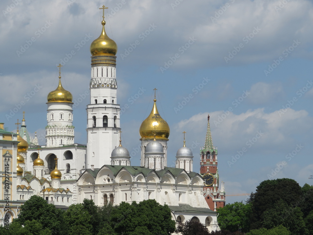 Ivan the Great bell tower against a cloudy blue sky, a masterpiece of Russian architecture. Moscow Kremlin in summer