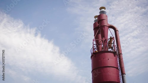 Red sawdust tank and blue sky