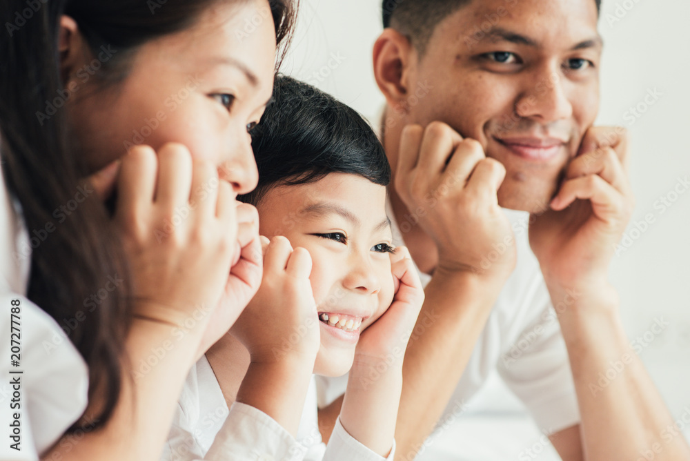 Happy aian family lying in bed and sleeping. Happy aian family lying in bed and sleeping.