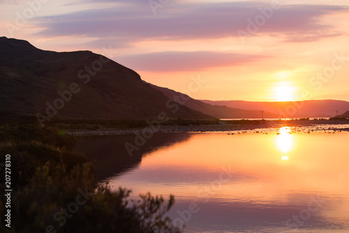 Summer sunrise reflections on lake in Scottish Isle of Skye
