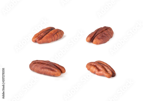 Pecan nuts topped with light salt isolated in pieces on white background, macro shot (clipping path included of each piece)