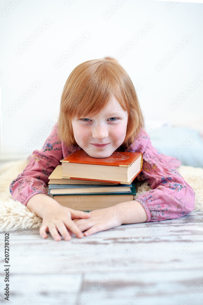 The girl hugs her favorite books