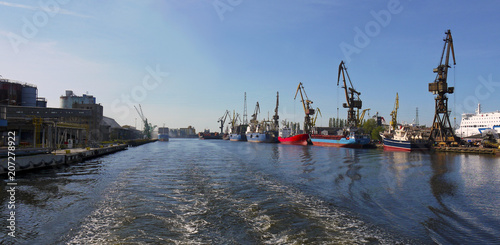 Shipping cranes in Gdansk stock images. Industrial site in Poland. Cargo cranes during the day. Shipping in Poland