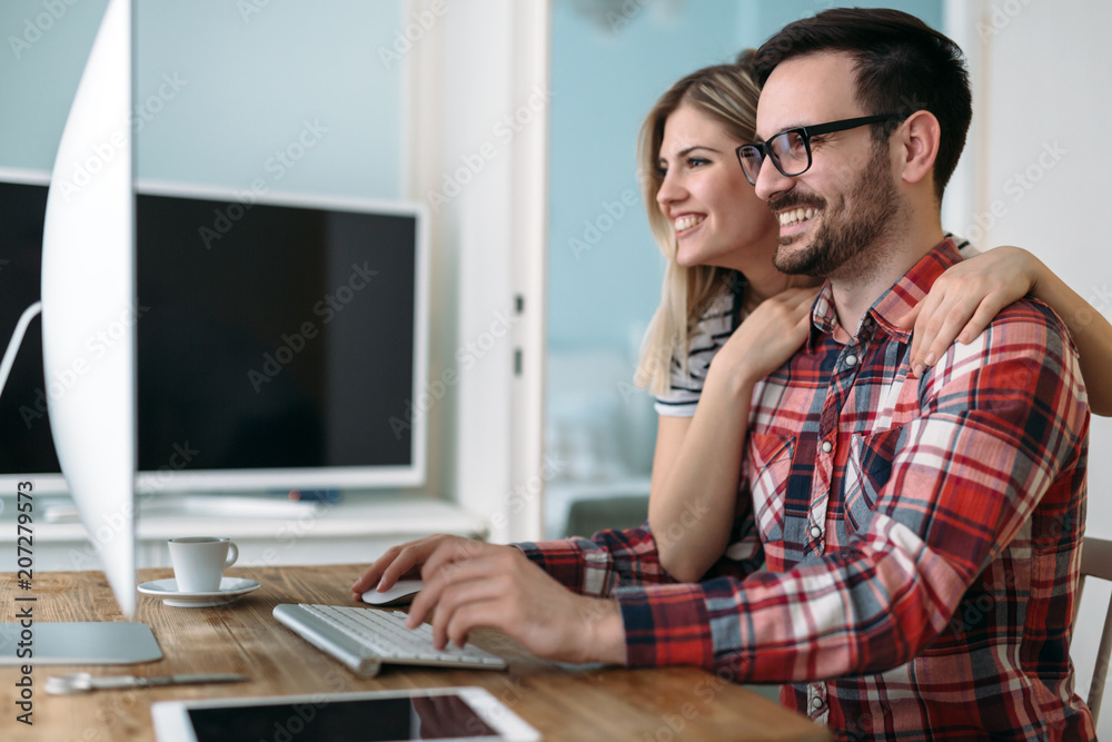 Young attractive designers working on project together