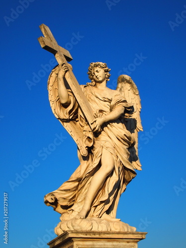  Marble statue of angel with cross from the Sant'Angelo Bridge in Rome, Italy © snowflake26
