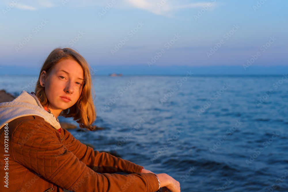 Portrait of young beautiful lady admiring the summer landscape o