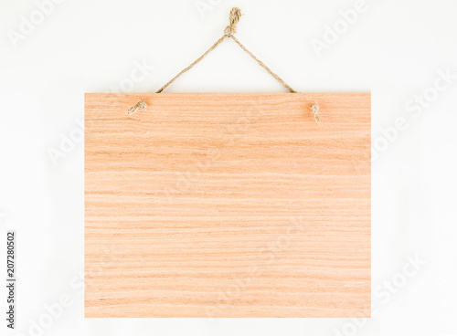 Labels made of natural wood, with a rope hanging on a white background, are empty.