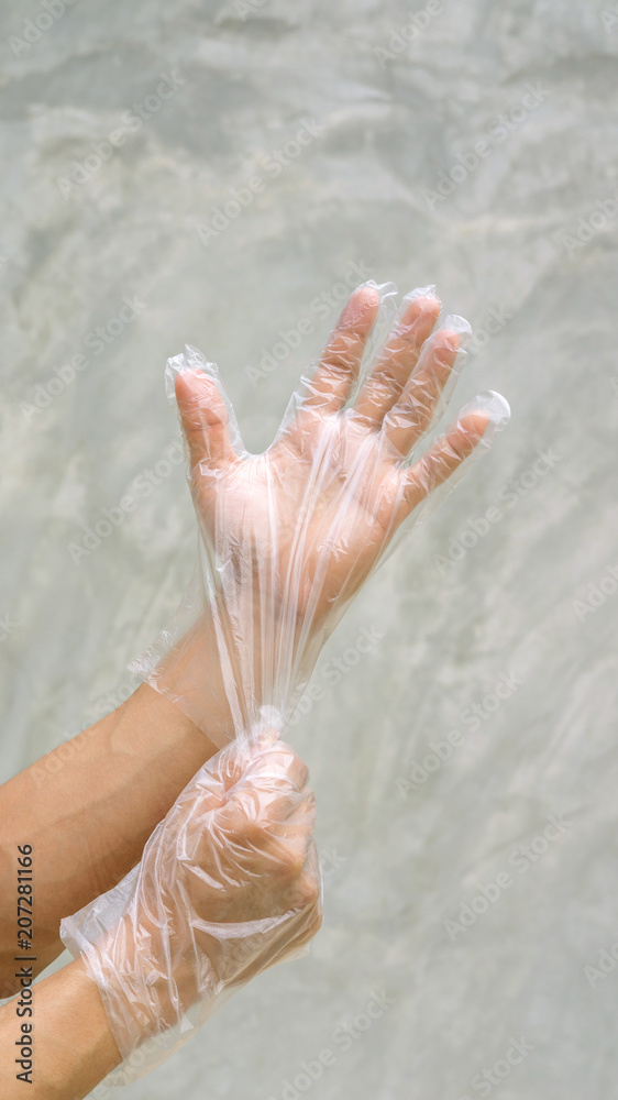 Fototapeta premium Men wear a glove on a gray background.