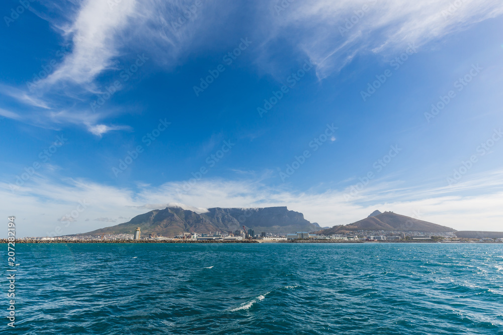 View of Table Mountain in Cape Town from the ocean with blue sky