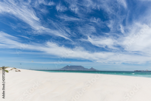 View of Table Mountain from Blouberg in Cape Town with wind surfers