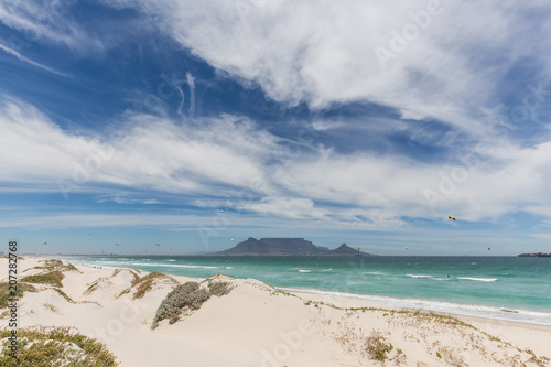 View of Table Mountain from Blouberg in Cape Town with wind surfers