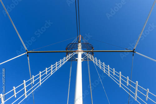 Mast of the ship against the blue sky.