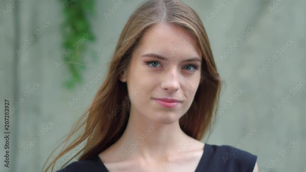 Half length image of sexy happy girl standing against stone wall. Beauty concept. Half length image of sexy happy girl standing against stone wall. Beauty concept.