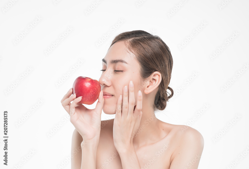beautiful asia woman with towel on head with perfect clean skin smiling holding apple slices over white background. Beauty cosmetology and spa. beautiful asia woman with towel on head with perfect clean skin smiling holding apple slices over white background. Beauty cosmetology and spa.