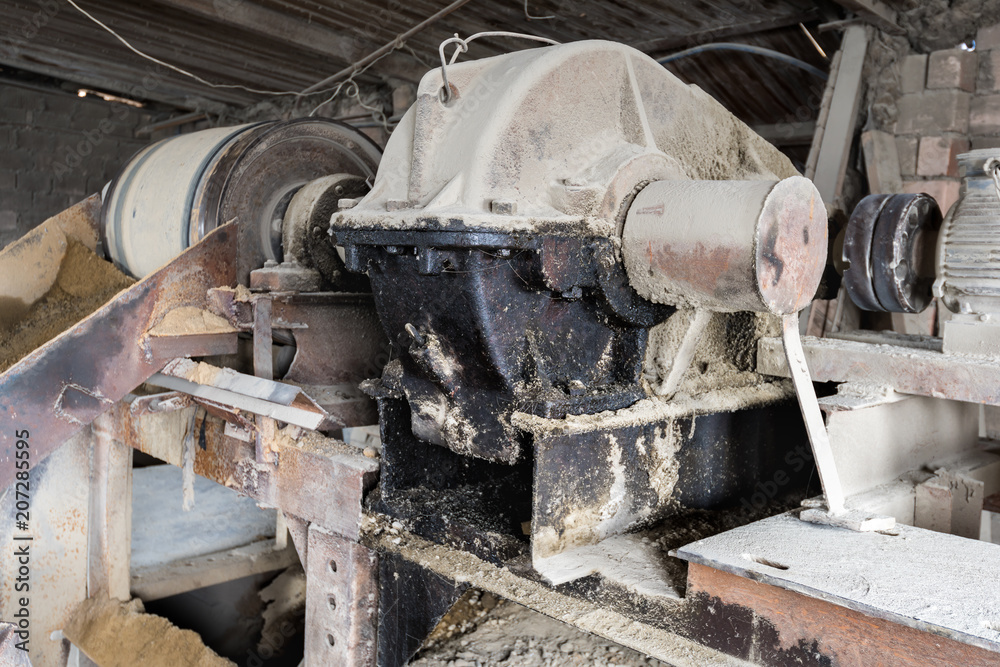 The aggregate distribution of materials for the production of concrete in the old Soviet factory.