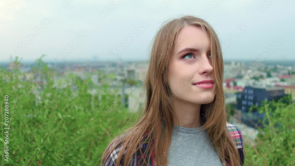 Nice girl in field on city background. Nature beauty concept. Nice girl in field on city background. Nature beauty concept.