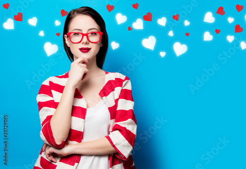 portrait of the beautiful young smiling woman on the blue background