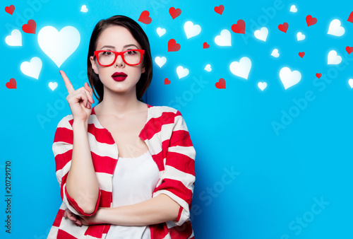 portrait of the beautiful young surprised woman on the blue background photo