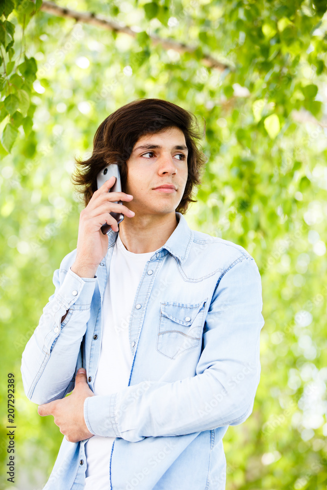 Young man talking on phone while standing outdoor Young man talking on phone while standing outdoor
