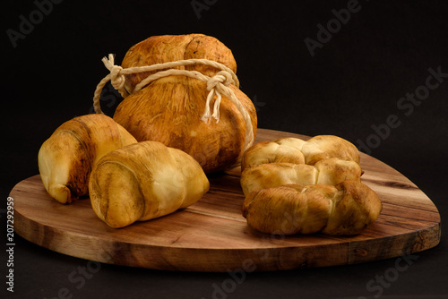 Smoked cheese pigtail isolated on black background photo