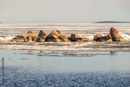 Stones on a frozen lake on a sunny day