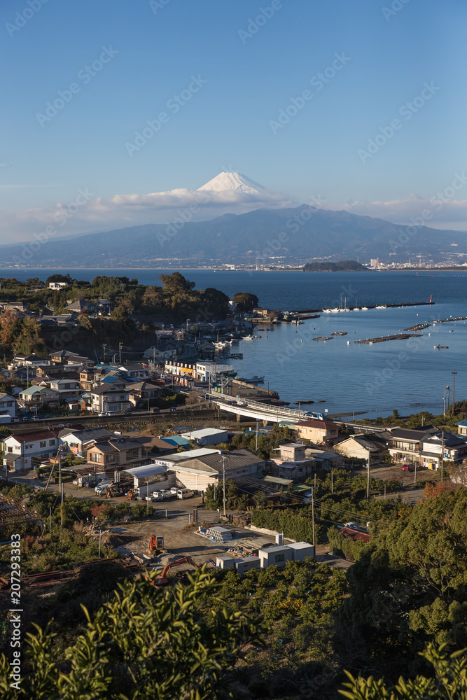 View of Izu town with Mountain Fuji and Suruga bay in winter evening.