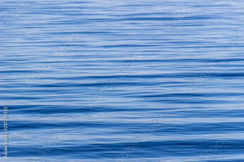 Surface with waves of the blue sea, background, texture