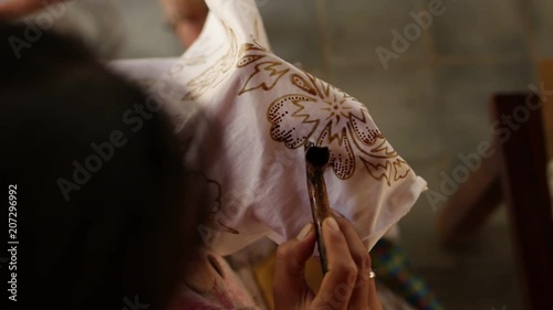 Detail of waxing the drawing to textile for making batik. Bali island.