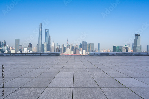 city skyline with empty floor in urban square