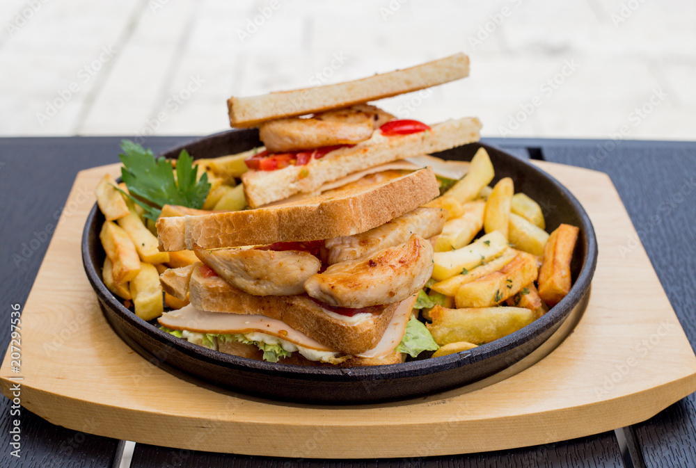 Chicken sandwich in toast bread, with French fries as a bowl, on a white background, restaurant, served Chicken sandwich in toast bread, with French fries as a bowl, on a white background, restaurant, served