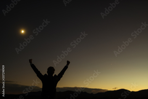 Triumphant businessman greeting a new day standing outdoors