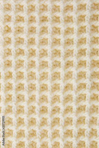 Background of crocheted wool thread of yellow color.