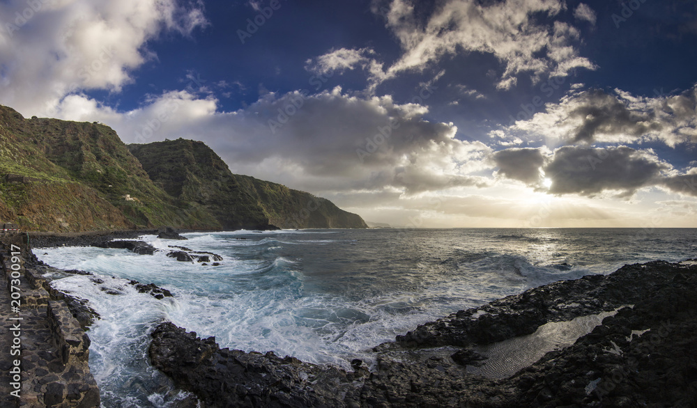 sunset on tenerife island with view on ocean with waves