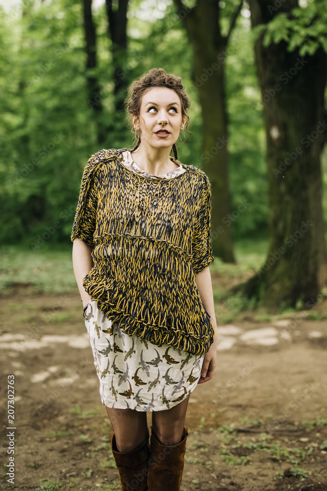 Fototapeta premium Young woman wearing sweater and posing the park