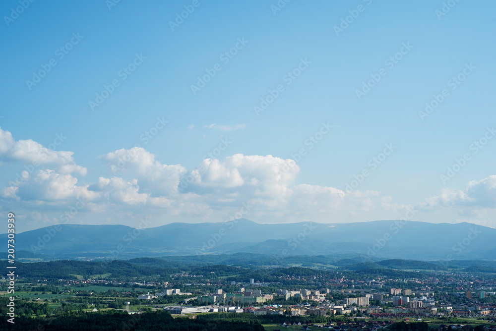 panorama view of the valley (city) at the foot of the mountains in the distance