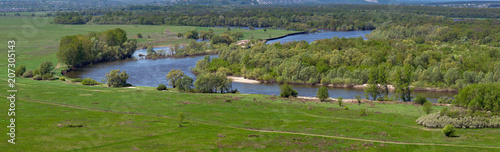 Landscape in the valley of the Don River in central Russia. Top view of the spring meadow with grass and pond.
