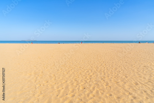 The sea and sand under a clear sky