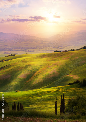 Italy; San Quirico d'Orcia; sunset over Tuscan Valdorcia rolling hills