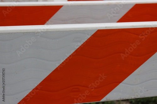 group of plastic orange and white a-frame traffic barriers