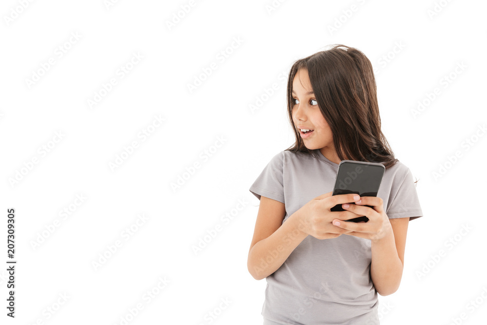 Cute girl standing isolated using mobile phone. Cute girl standing isolated using mobile phone.