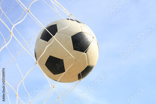 Soccer ball on net in goal