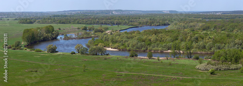 Landscape in the valley of the Don River in central Russia. Top view of the spring meadow with grass and pond.