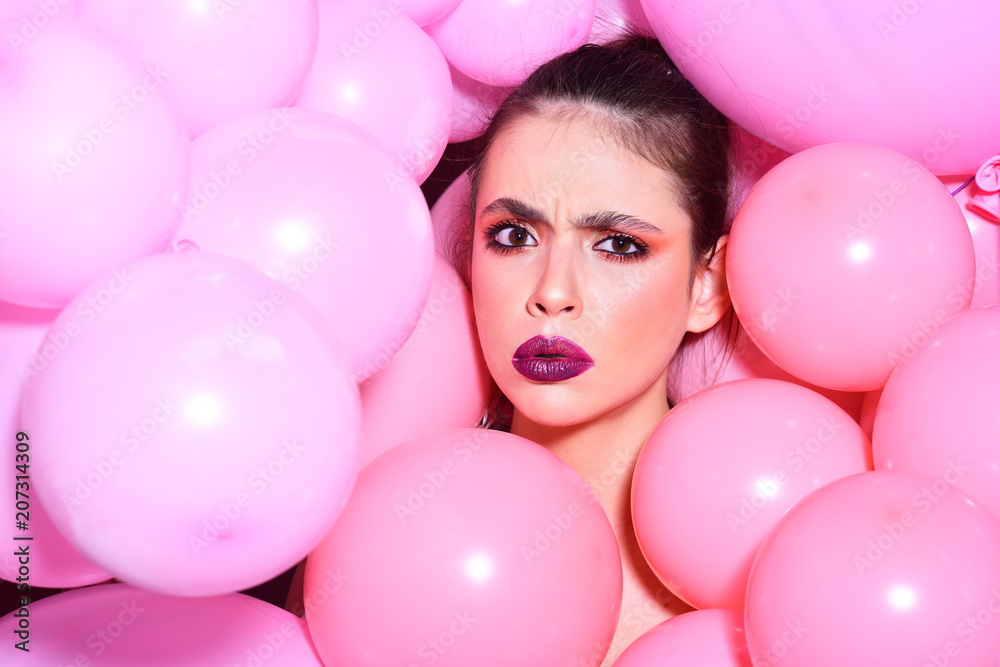 Obraz premium Balloon party on pink studio background. Birthday decor and celebration. girl dreaming in punchy pastels trend. Retro girl with stylish makeup and hair. Fashion woman with many pink air balloons